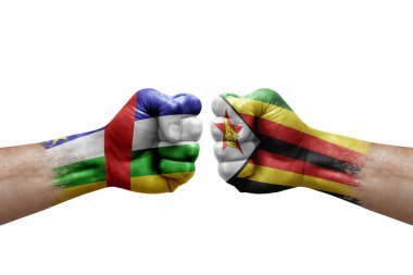 Two hands punch to each others on white background. Country flags painted fists, conflict crisis concept between central african republic and zimbabwe