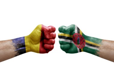 Two hands punch to each others on white background. Country flags painted fists, conflict crisis concept between chad and dominica