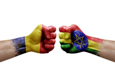 Two hands punch to each others on white background. Country flags painted fists, conflict crisis concept between chad and ethiopia
