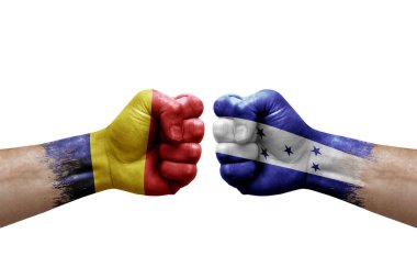 Two hands punch to each others on white background. Country flags painted fists, conflict crisis concept between chad and honduras