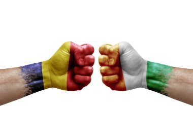 Two hands punch to each others on white background. Country flags painted fists, conflict crisis concept between chad and ivory coast