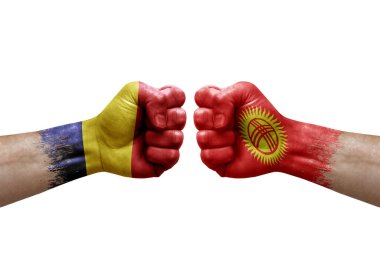 Two hands punch to each others on white background. Country flags painted fists, conflict crisis concept between chad and kyrgyzstan