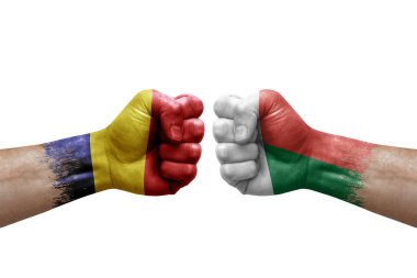 Two hands punch to each others on white background. Country flags painted fists, conflict crisis concept between chad and madagascar