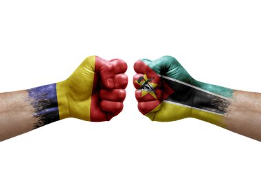 Two hands punch to each others on white background. Country flags painted fists, conflict crisis concept between chad and mozambique