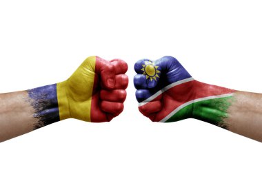 Two hands punch to each others on white background. Country flags painted fists, conflict crisis concept between chad and namibia