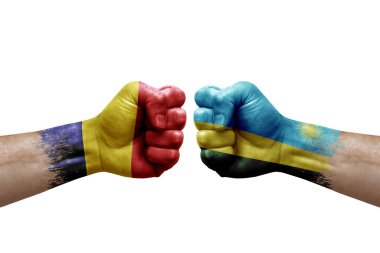 Two hands punch to each others on white background. Country flags painted fists, conflict crisis concept between chad and rwanda