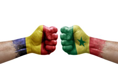 Two hands punch to each others on white background. Country flags painted fists, conflict crisis concept between chad and senegal