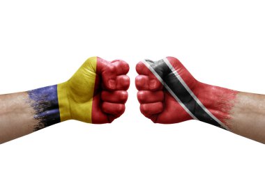 Two hands punch to each others on white background. Country flags painted fists, conflict crisis concept between chad and tobago