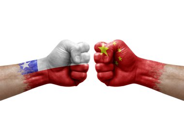Two hands punch to each others on white background. Country flags painted fists, conflict crisis concept between chile and china