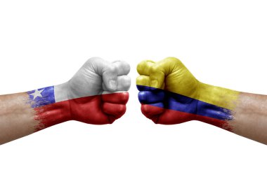 Two hands punch to each others on white background. Country flags painted fists, conflict crisis concept between chile and colombia