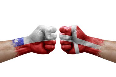 Two hands punch to each others on white background. Country flags painted fists, conflict crisis concept between chile and denmark
