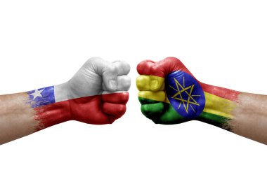 Two hands punch to each others on white background. Country flags painted fists, conflict crisis concept between chile and ethiopia