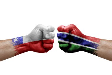 Two hands punch to each others on white background. Country flags painted fists, conflict crisis concept between chile and gambia
