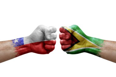 Two hands punch to each others on white background. Country flags painted fists, conflict crisis concept between chile and guyana