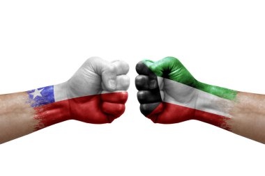 Two hands punch to each others on white background. Country flags painted fists, conflict crisis concept between chile and kuwait