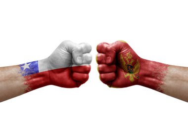 Two hands punch to each others on white background. Country flags painted fists, conflict crisis concept between chile and montenegro