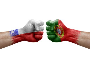 Two hands punch to each others on white background. Country flags painted fists, conflict crisis concept between chile and portugal