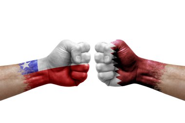 Two hands punch to each others on white background. Country flags painted fists, conflict crisis concept between chile and qatar