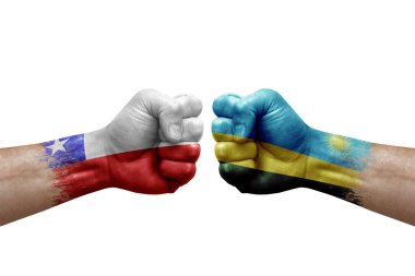 Two hands punch to each others on white background. Country flags painted fists, conflict crisis concept between chile and rwanda