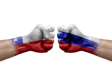 Two hands punch to each others on white background. Country flags painted fists, conflict crisis concept between chile and russia