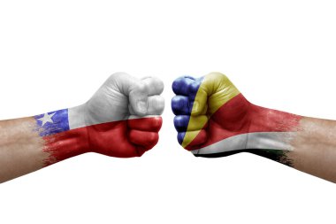 Two hands punch to each others on white background. Country flags painted fists, conflict crisis concept between chile and seychelles