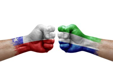 Two hands punch to each others on white background. Country flags painted fists, conflict crisis concept between chile and sierra leone
