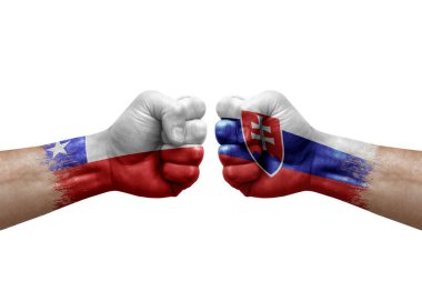 Two hands punch to each others on white background. Country flags painted fists, conflict crisis concept between chile and slovakia
