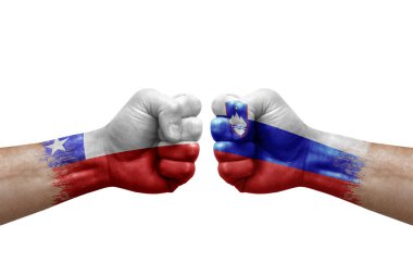 Two hands punch to each others on white background. Country flags painted fists, conflict crisis concept between chile and slovenia