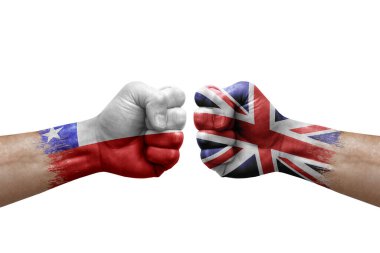 Two hands punch to each others on white background. Country flags painted fists, conflict crisis concept between chile and united kingdom