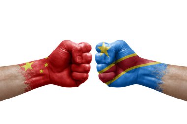 Two hands punch to each others on white background. Country flags painted fists, conflict crisis concept between china and dr congo