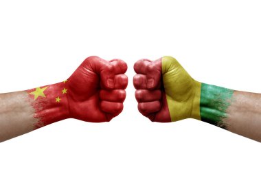 Two hands punch to each others on white background. Country flags painted fists, conflict crisis concept between china and guinea