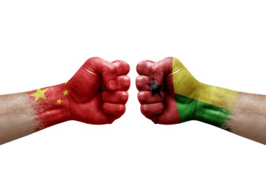 Two hands punch to each others on white background. Country flags painted fists, conflict crisis concept between china and guinea-bissau