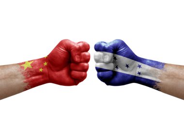 Two hands punch to each others on white background. Country flags painted fists, conflict crisis concept between china and honduras