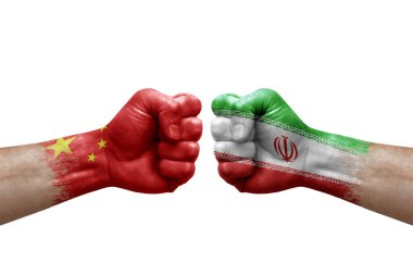 Two hands punch to each others on white background. Country flags painted fists, conflict crisis concept between china and iran