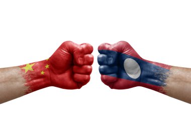 Two hands punch to each others on white background. Country flags painted fists, conflict crisis concept between china and laos