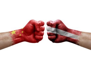 Two hands punch to each others on white background. Country flags painted fists, conflict crisis concept between china and latvia