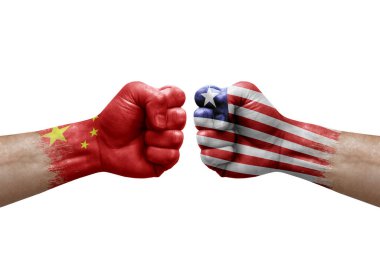 Two hands punch to each others on white background. Country flags painted fists, conflict crisis concept between china and liberia