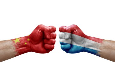 Two hands punch to each others on white background. Country flags painted fists, conflict crisis concept between china and luxembourg