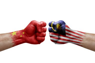 Two hands punch to each others on white background. Country flags painted fists, conflict crisis concept between china and malaysia