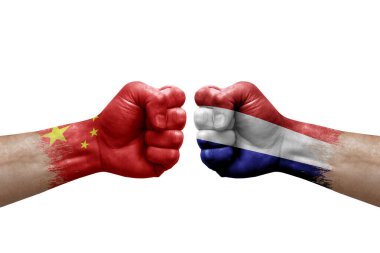 Two hands punch to each others on white background. Country flags painted fists, conflict crisis concept between china and netherlands