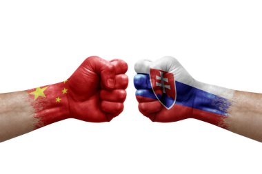 Two hands punch to each others on white background. Country flags painted fists, conflict crisis concept between china and slovakia