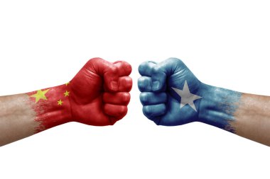 Two hands punch to each others on white background. Country flags painted fists, conflict crisis concept between china and somalia