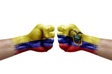 Two hands punch to each others on white background. Country flags painted fists, conflict crisis concept between colombia and ecuador