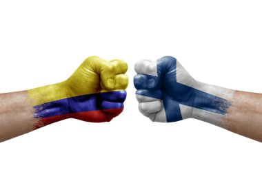 Two hands punch to each others on white background. Country flags painted fists, conflict crisis concept between colombia and finland