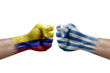 Two hands punch to each others on white background. Country flags painted fists, conflict crisis concept between colombia and greece