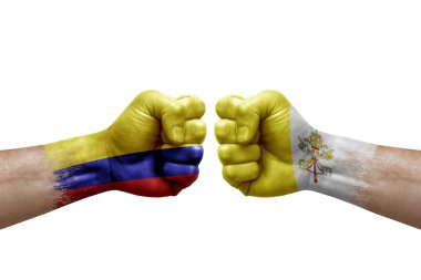 Two hands punch to each others on white background. Country flags painted fists, conflict crisis concept between colombia and holy see