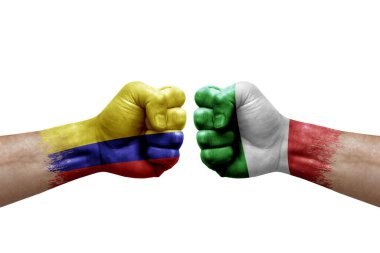 Two hands punch to each others on white background. Country flags painted fists, conflict crisis concept between colombia and italy