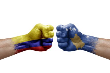 Two hands punch to each others on white background. Country flags painted fists, conflict crisis concept between colombia and kosovo