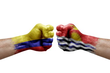 Two hands punch to each others on white background. Country flags painted fists, conflict crisis concept between colombia and kiribati