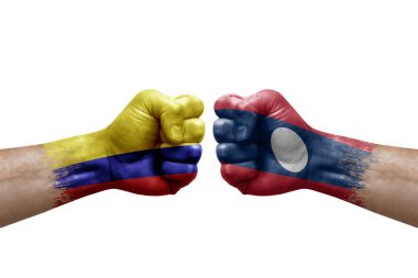 Two hands punch to each others on white background. Country flags painted fists, conflict crisis concept between colombia and laos